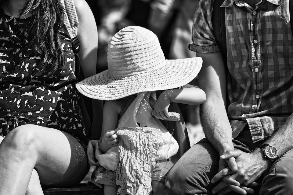young girl in sun hat with bag of food