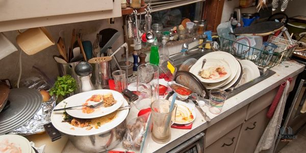 sink and counter full of dirty dishes and clutter